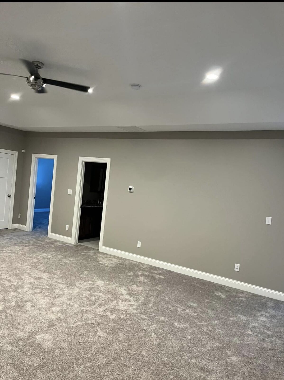Basement family room with freshly painted walls and white doors
