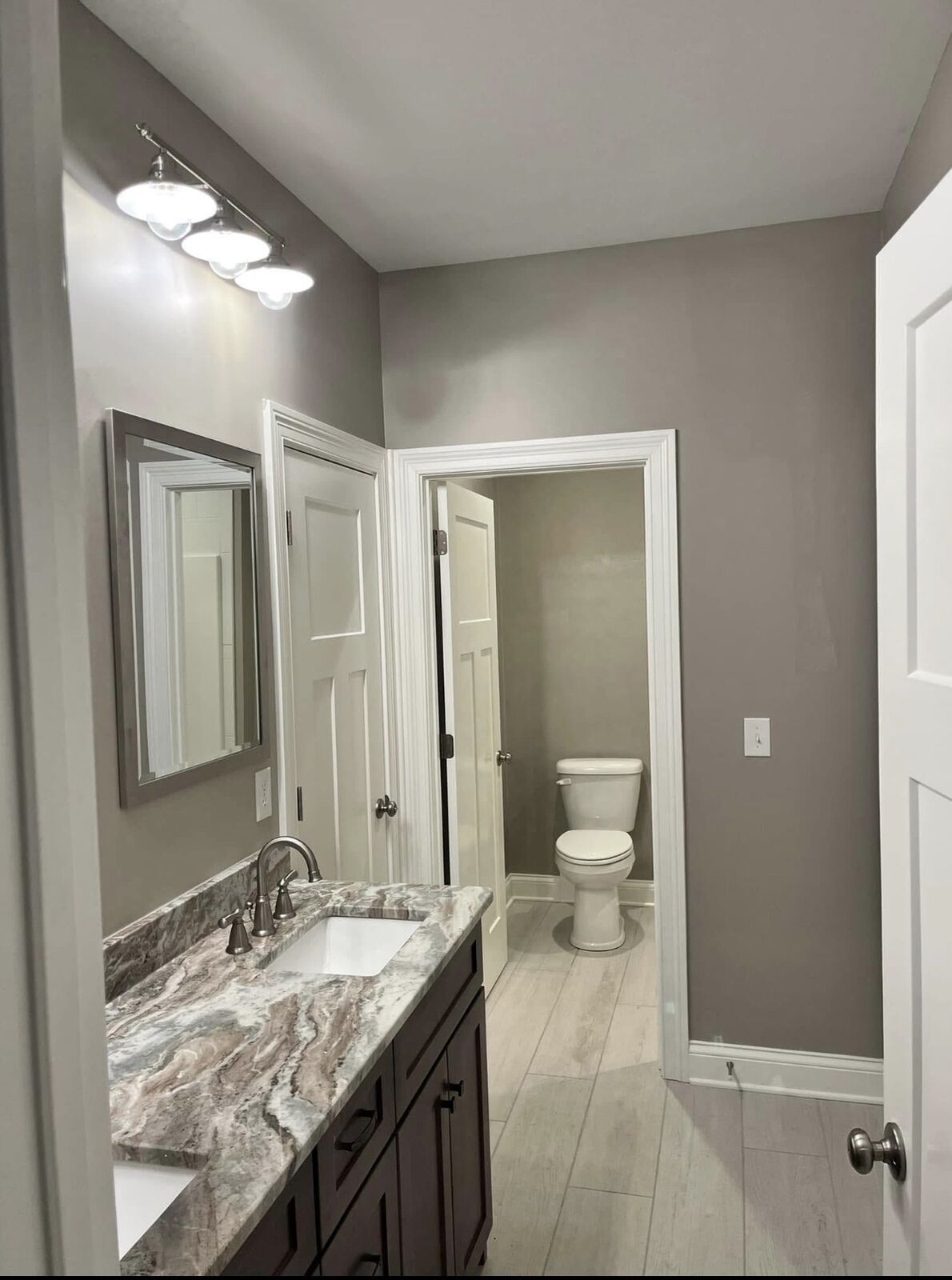 Bathroom with freshly painted gray walls and white trim