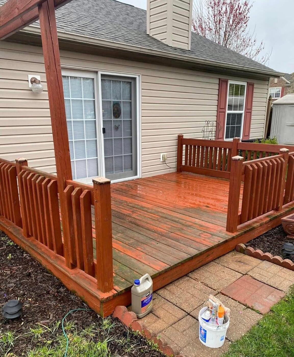 Backyard deck and railings refinished with a rich red stain