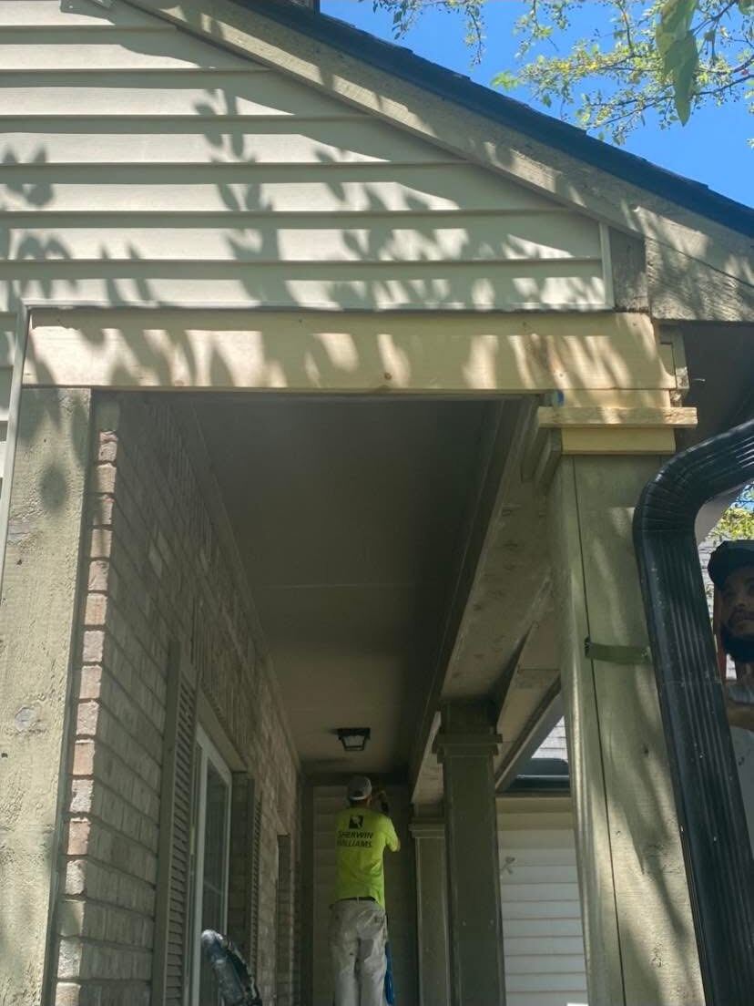 Freshly painted soffit and trim over a covered front entry