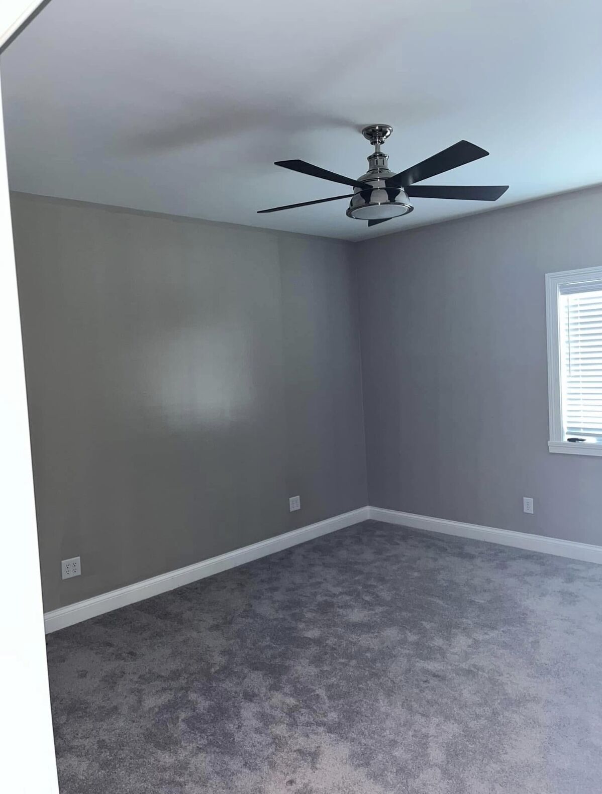 Bedroom painted a cool gray with white trim