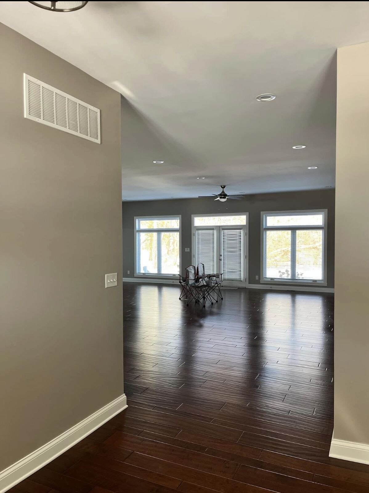 Painted hallway opening into a bright great room