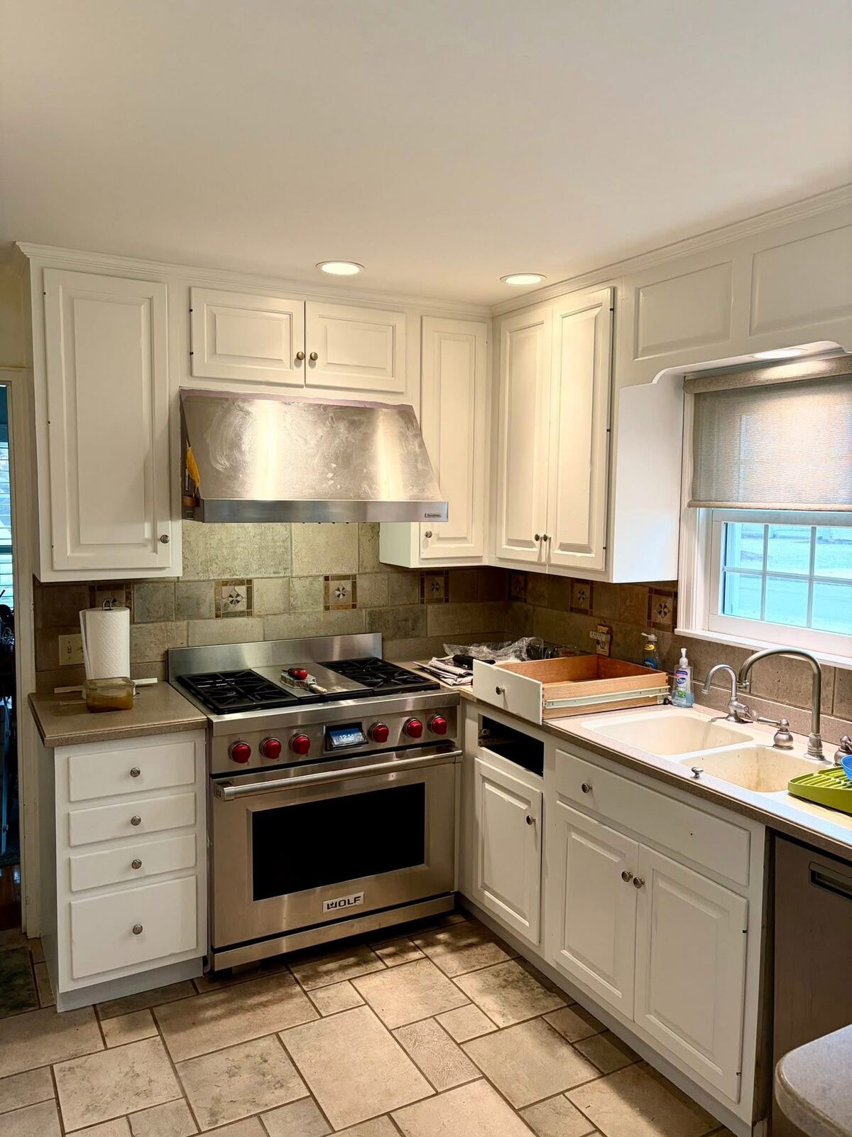 Kitchen with freshly painted white cabinets and stainless appliances