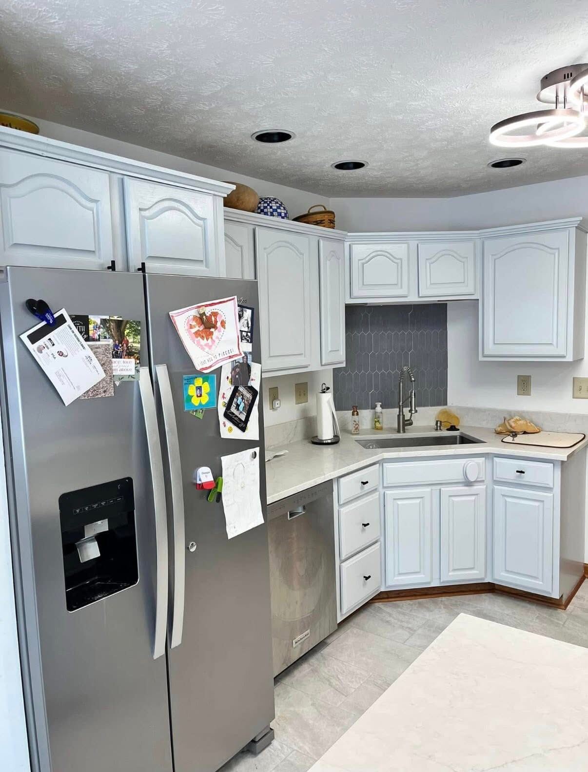 Corner kitchen with freshly painted white cabinets