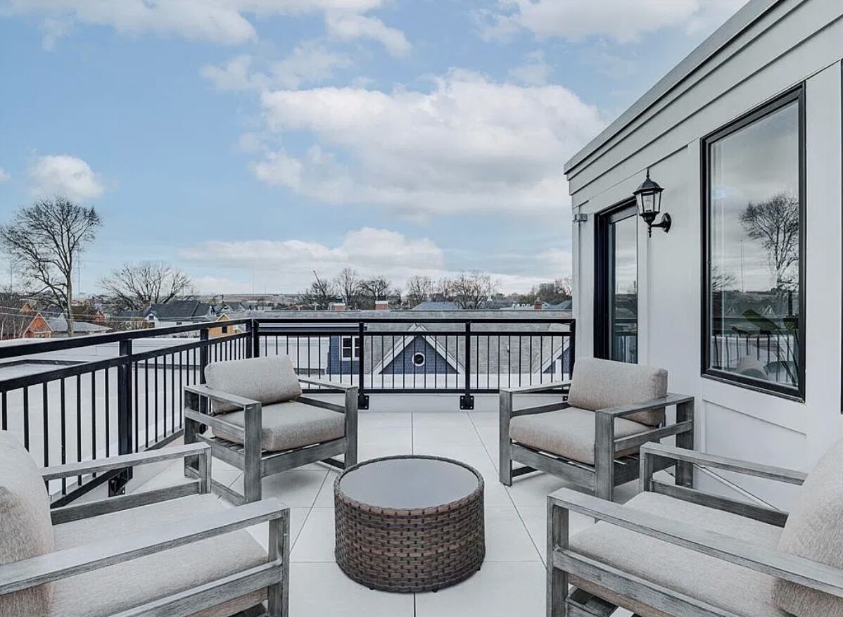Rooftop seating area beside freshly painted exterior walls