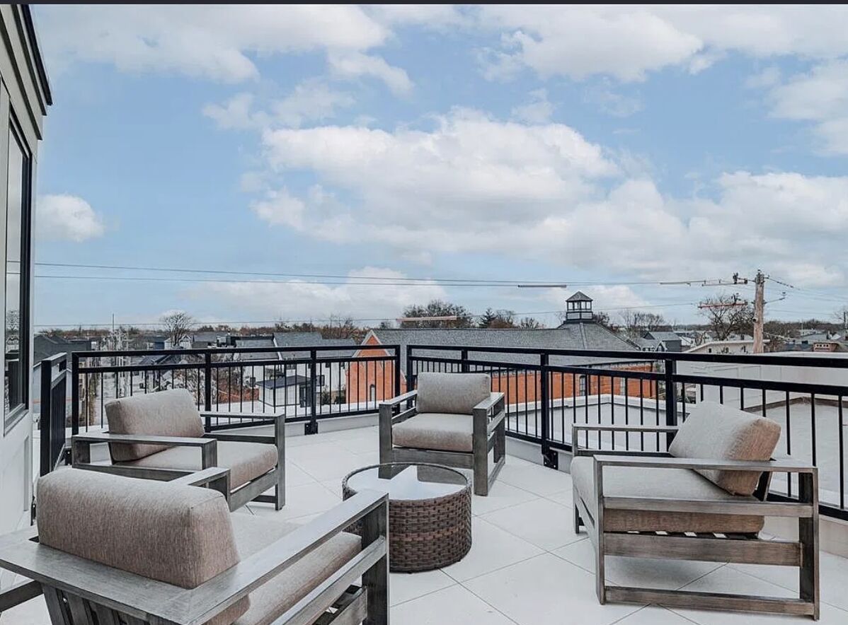 Rooftop deck with painted exterior walls overlooking the city