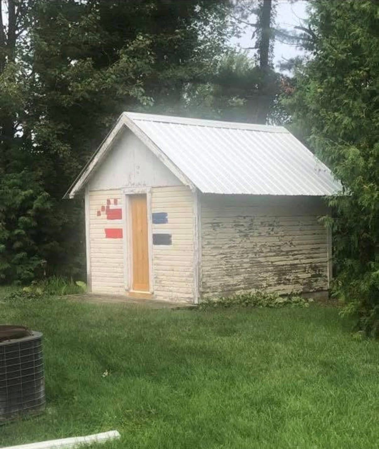 Weathered backyard shed before painting